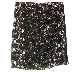 Black lace on top of a light pink mini skirt
